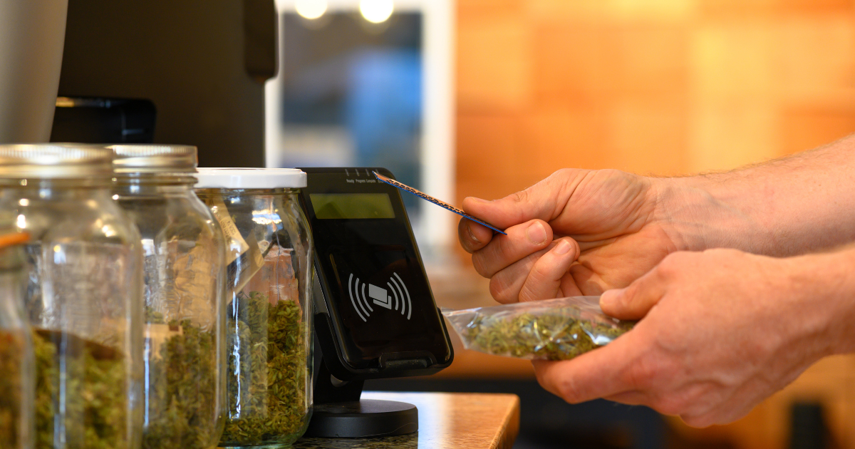Inside of a licensed cannabis dispensary where a patron is purchasing cannabis with the use of easy pay. Learn more about New York's booming cannabis industry and unlock data on license holders with CannaSpyglass.