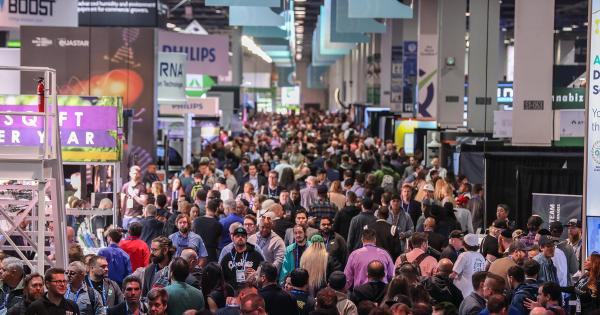 A photo of a crowd walking around the cannabis convention floor at MJBizCon. CannaSpyglass provides all the information for upcoming 2024 cannabis conferences.