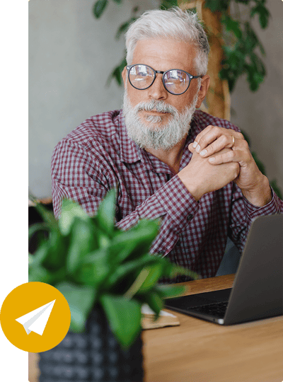 An individual seated at a desk considering potential cannabis email marketing strategies. An individual seated at a desk considering potential cannabis email marketing strategies.