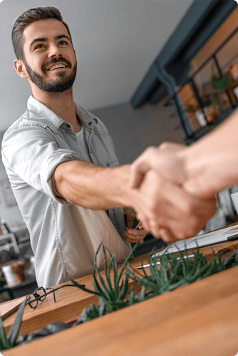 Image of a consultant shaking hands with client