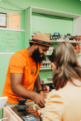 Image of a man working behind the counter of a cannabis dispensary