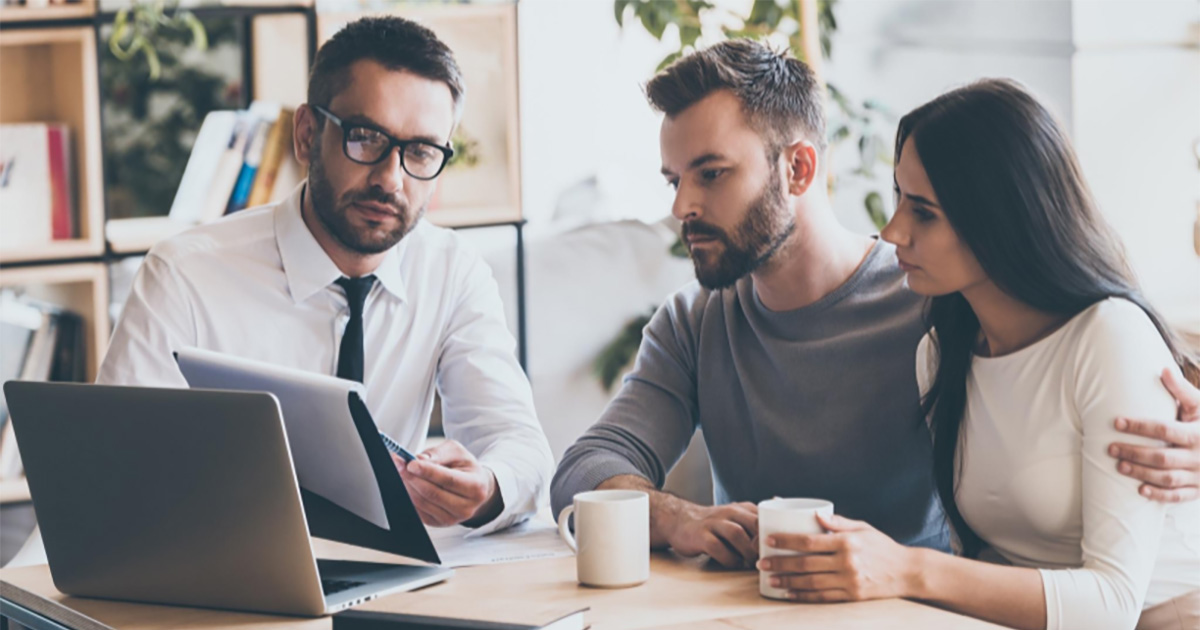 Three individuals discussing cannabis business data provided by CannaSpyglass.